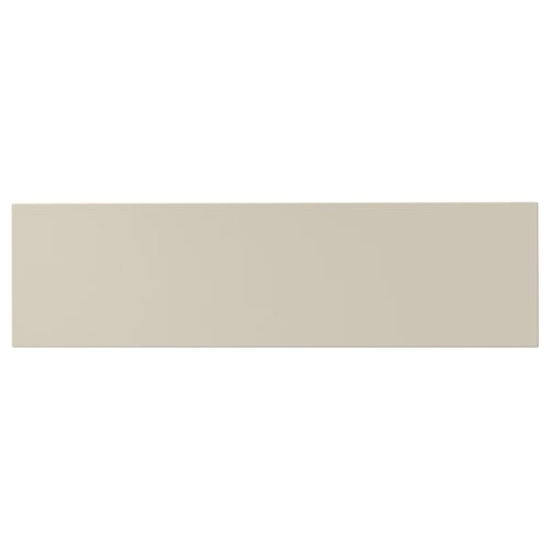 A beige HAVSTORP kitchen cabinet front. Its rectangular, flat, and smooth with clean lines, made from acrylic paint and fiberboard.