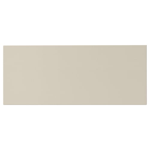 A rectangular, beige-colored HAVSTORP front piece made from acrylic-painted fibreboard.