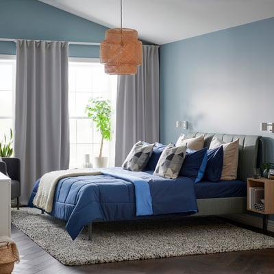 Bedroom with blue HEDFRYLE comforter set on bed, soft recycled polyester, modern look.