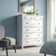 HEMNES dresser in bedroom with 6 drawers, mirror, plant. Blue walls, grey curtains.