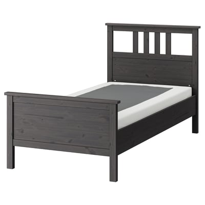 Dark grey HEMNES wooden bed with high headboard and mattress.