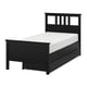 Black wooden bed with white mattress. Headboard, footboard, and two drawers for storage. Modern design.