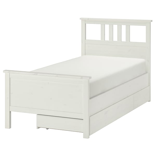 A white HEMNES bed with wooden drawers in a clean, modern design. Its a twin-size bed featuring solid pine construction and drawers for storage.