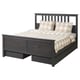 Modern grey wooden bed with chequered pillows and drawers.