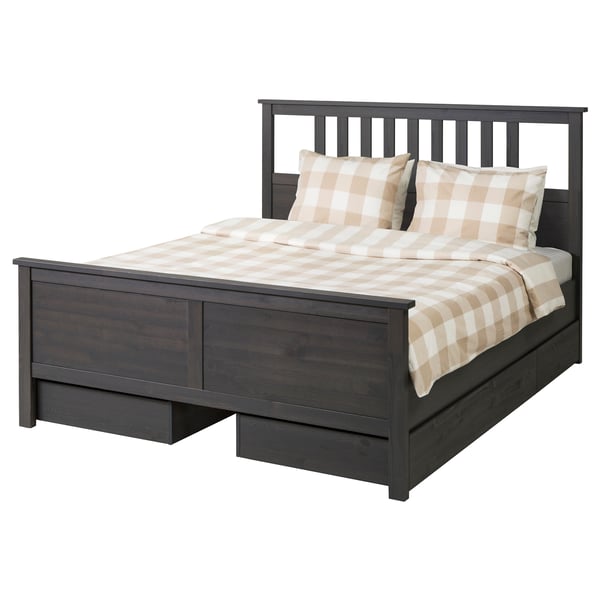 Dark grey wooden bed with chequered white and beige bedding, featuring a classic design with tall headboard and footboard.