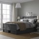 HEMNES dark brown bed, storage, grey bedding, large window, matching nightstands, lamps.