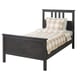 Dark grey HEMNES wood bed with checked beige and white linens.