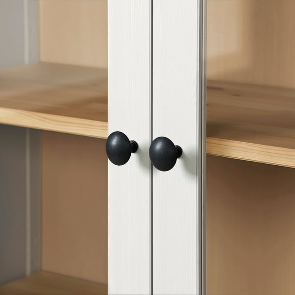 Wooden cabinet with black knobs, two shelves, sturdy, well-crafted.