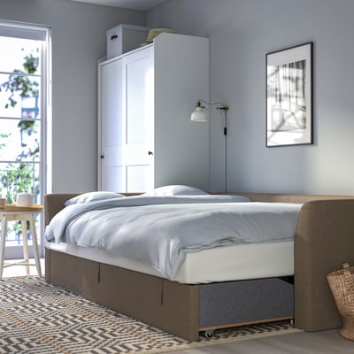 Modern sofa bed transforms into a comfortable bed, ideal for small spaces. Includes storage under seats and removable cushions for versatility.