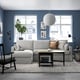 Modern living room with grey sectional sofa, coffee table, and decor.