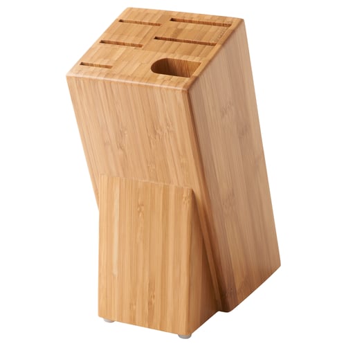 The HYVLA knife block made of light bamboo with slots for 5 knives and a whetstone, standing upright.