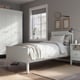 Modern bedroom with white IDANÄS bed and wardrobe, grey walls, and a window with wooden frames.