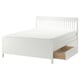 A white IDANÄS bed with slatted headboard and under-bed storage drawers for efficient space use.