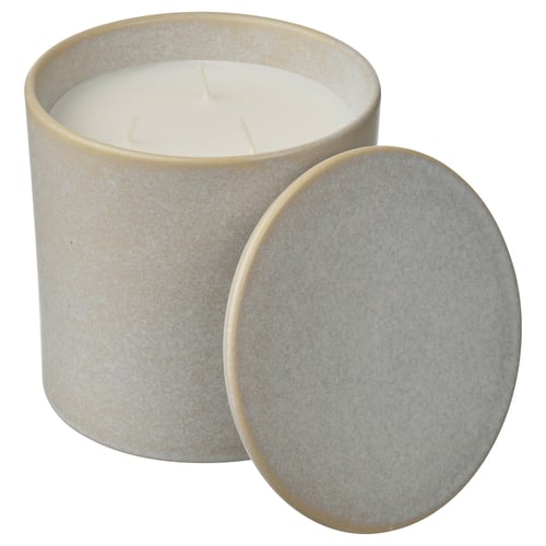 Cylindrical light beige ceramic candle jar with lid. Holds 3-wick candle with sweet peas scent. Lid can be used as coaster.