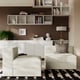 Modern minimalist living room with JÄTTEBO sofa modules in light green, geometric rug, white cabinet, and stylish decor.