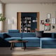 Modern living room with blue modular sofa, chaise, & wooden coffee table.