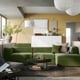 Modular green sofa set in modern living room. Olive cushions, wooden coffee table, and sleek decor.