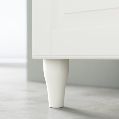 Single white cabinet leg with slight curve; minimalist, modern design.