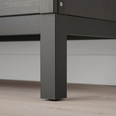 Close-up of a sleek, black metal furniture leg, showing smooth finish and sturdy build.