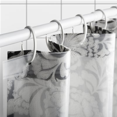 Black and white floral shower curtain with cotton-jute blend, hanging straight, semi-sheer.