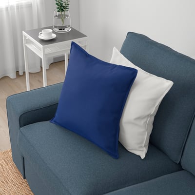 A cosy blue sofa with removable armrests, perfect for relaxation and naps.