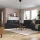 Modern living room with large grey KIVIK sectional sofa, wooden coffee tables, and large windows. Light pink walls and soft rug.