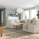 Modern living room with grey KIVIK sofa, black-white rug, pendant lamp, coffee table, and large windows.