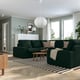 Modern living room with green KIVIK sofa, striped rug, wooden floor, and large windows. Pendant light over seating area.