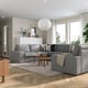 Modern living room with KIVIK sofa, wooden coffee table, pendant light, large windows, and city views.