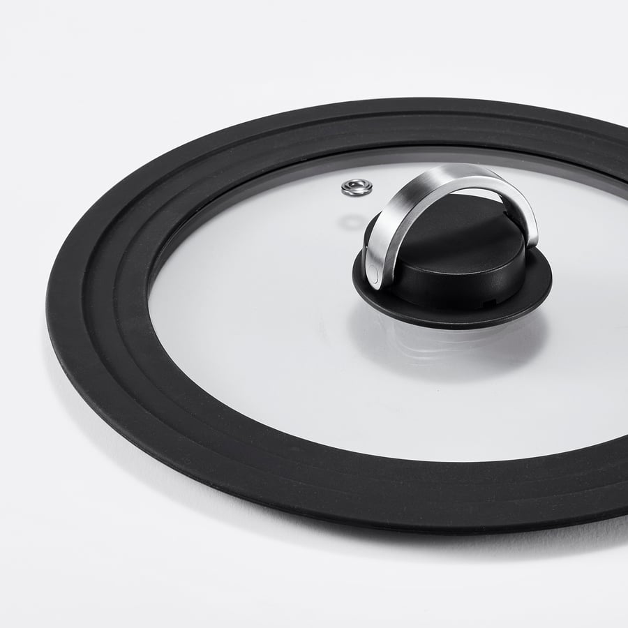 A modern, durable pot lid with a clear glass cover, a black silicone rim, and a metallic handle, designed for various pot sizes.