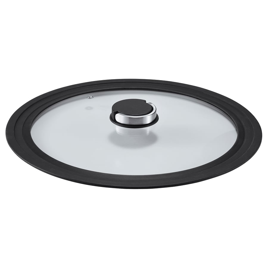 A KLOCKREN glass lid with a black silicone rim and foldable handle. Circular, transparent with black accents.