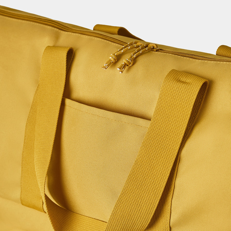 Close-up of a durable, mustard-colored tote bag with thick shoulder straps and a drawstring zip pull, highlighting its sturdy construction.