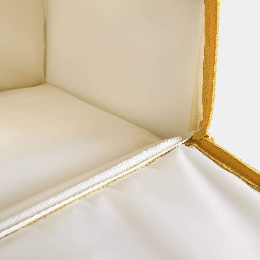 A close-up view of a sturdy, creamy-colored cooling bag with gold zippers and accents, showcasing high-quality design and craftsmanship.
