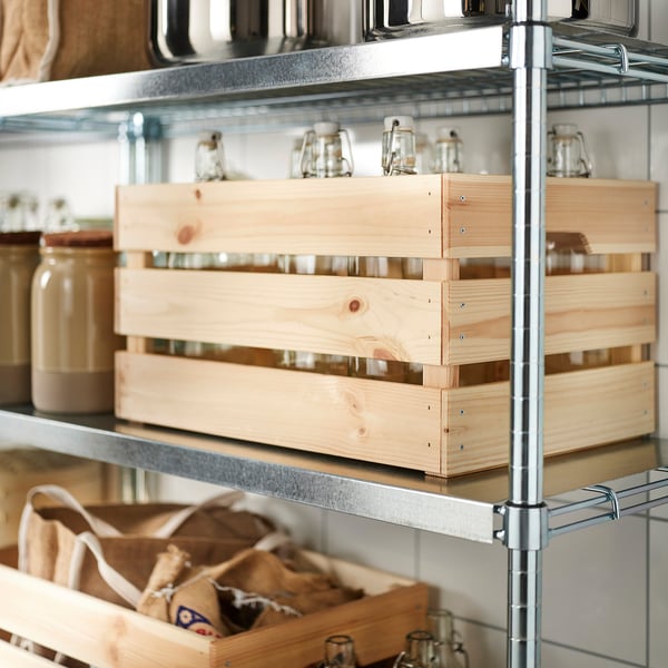 Metal shelf holding wooden KNAGGLIG boxes, storing glass jars and bags.