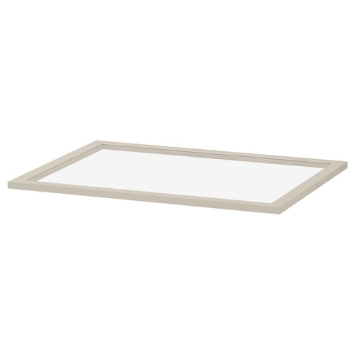 A KOMPLEMENT glass shelf in beige. It has a rectangular shape with a fibreboard frame and tempered glass centre, designed for wardrobe storage.