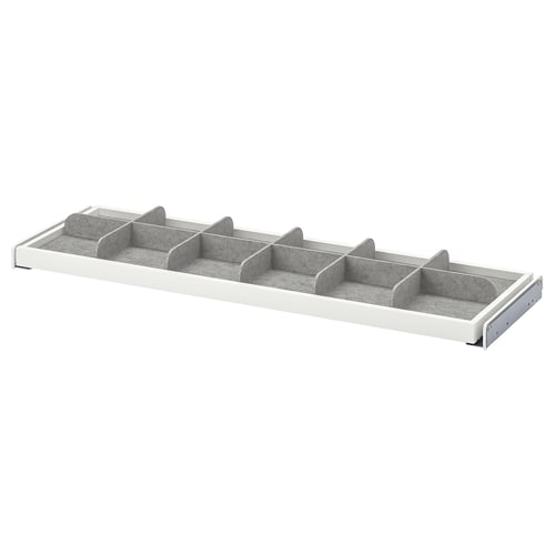 A KOMPLEMENT grey and white drawer divider with multiple compartments for organising small items.