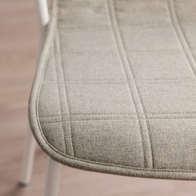 Grey chair cushion with diamond pattern, soft texture, neat stitching on round seat edge.
