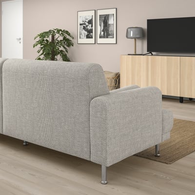 Grey LÅNGARYD sofa in minimalist living room with tv, plant, and artwork.