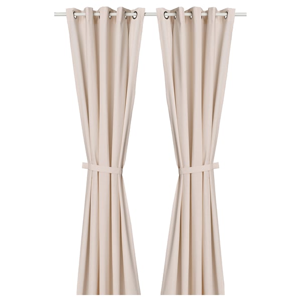 Pink curtains with dark specks, tiebacks, & stainless eyelets.