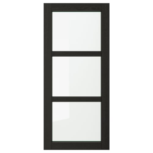 A black LERHYTTAN kitchen cabinet door with a solid wood frame, bevelled edges, and glass panel, giving it a traditional look.