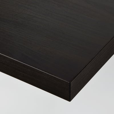 Close-up of sleek, black tabletop with smooth, even finish and clean, mitred edges.