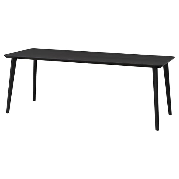 Minimalist black rectangular dining table with sleek metal legs, modern design.