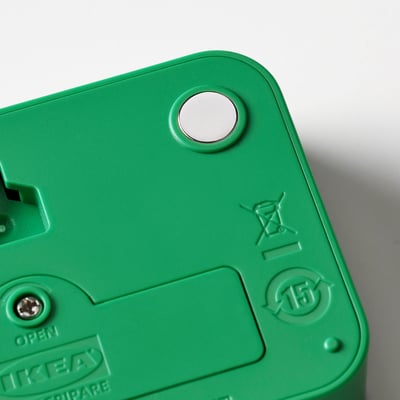 Close-up of green LJUNGPIPARE clocks back, featuring magnet and recycling symbols.