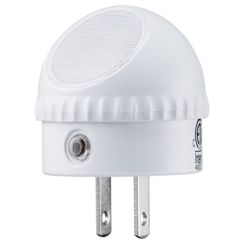 White dome-shaped nightlight with two metal prongs, made of polycarbonate plastic, featuring a ribbed base and a textured top.
