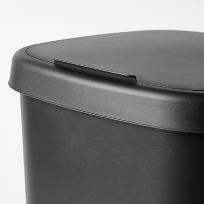 Close-up of sleek, black bin lid with smooth curves and small handle, showcasing its modern design and easy-to-clean surface.