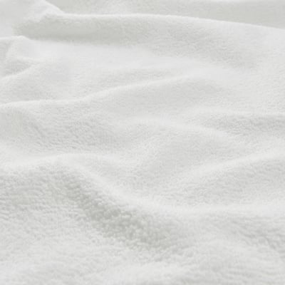 Soft, white cotton towel; smooth, even texture, sign of high quality.