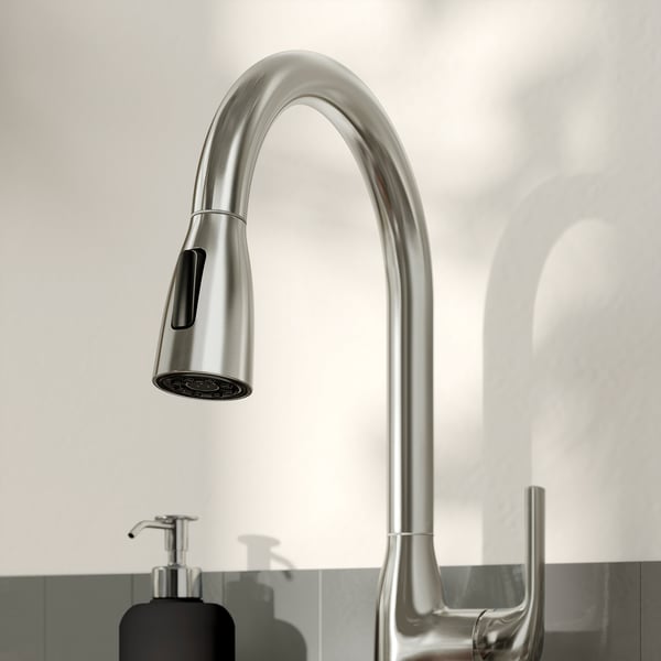 Stainless steel kitchen tap with pull-down sprayer, modern design, on a white countertop.