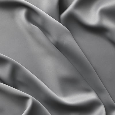Soft, grey curtains with elegant folds. Buttery texture, offering privacy and light blockout.
