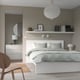 Modern bedroom with MALM bed, green walls, soft lighting, and decor.
