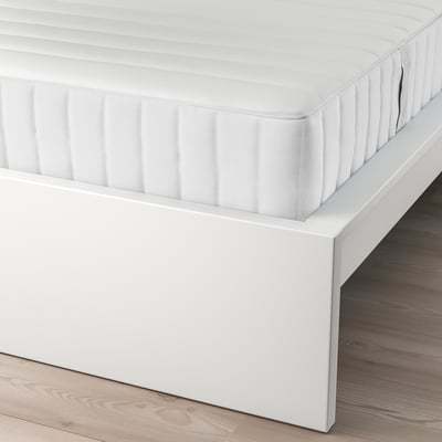 A white MALM bed frame with an adjustable headboard and storage.